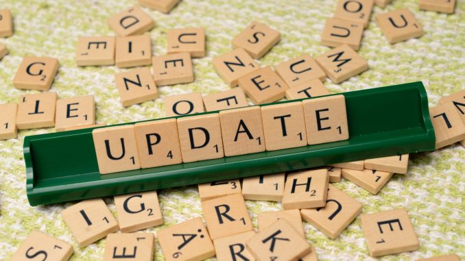 the word update is spelled out in scrabble tiles