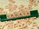 the word update is spelled out in scrabble tiles