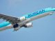 airborne commercial airplane against blue sky