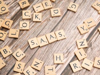 scrabble letters spelling saas on a wooden table