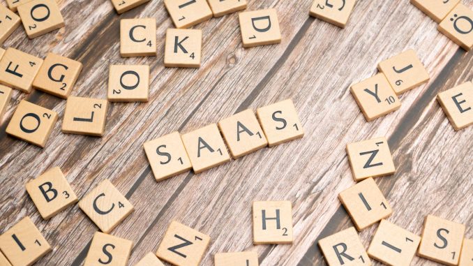 scrabble letters spelling saas on a wooden table
