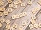 scrabble letters spelling saas on a wooden table