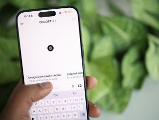 close up of a person holding a smartphone displaying chatgpt