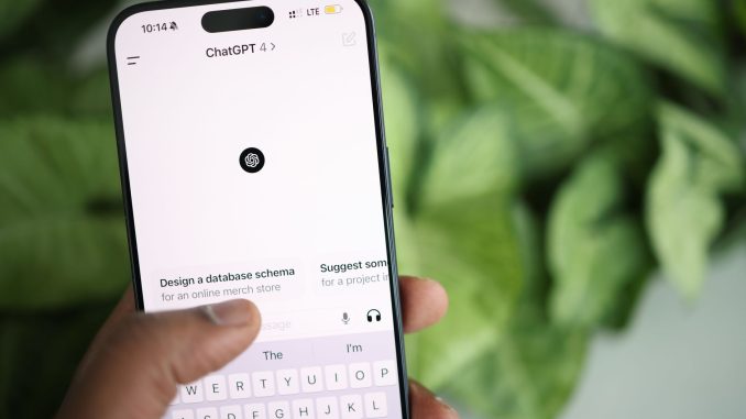 close up of a person holding a smartphone displaying chatgpt