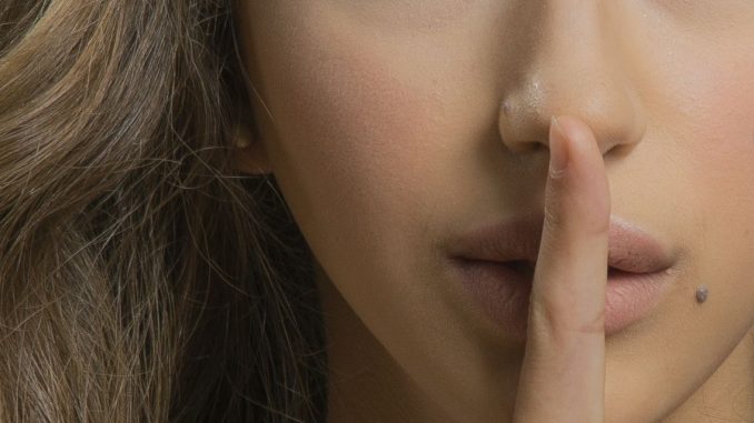 woman with blonde hair showing her finger