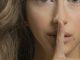 woman with blonde hair showing her finger